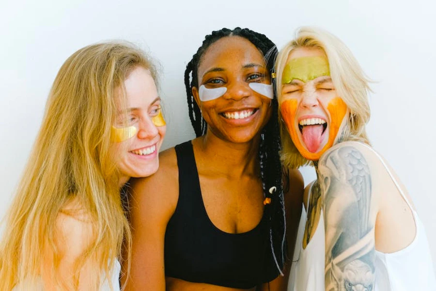 Three women with skincare products on their faces