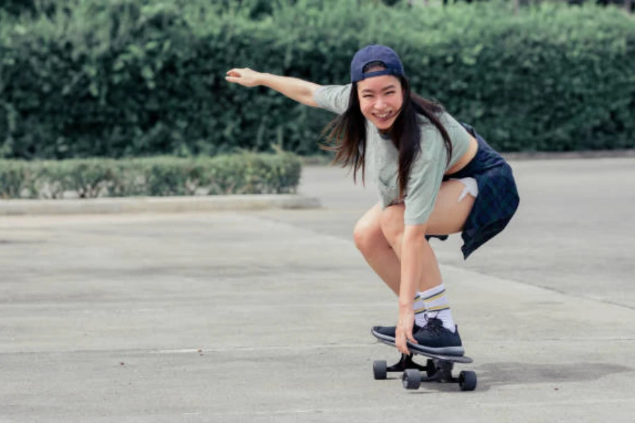 Woman riding a skateboard in an empty parking lot