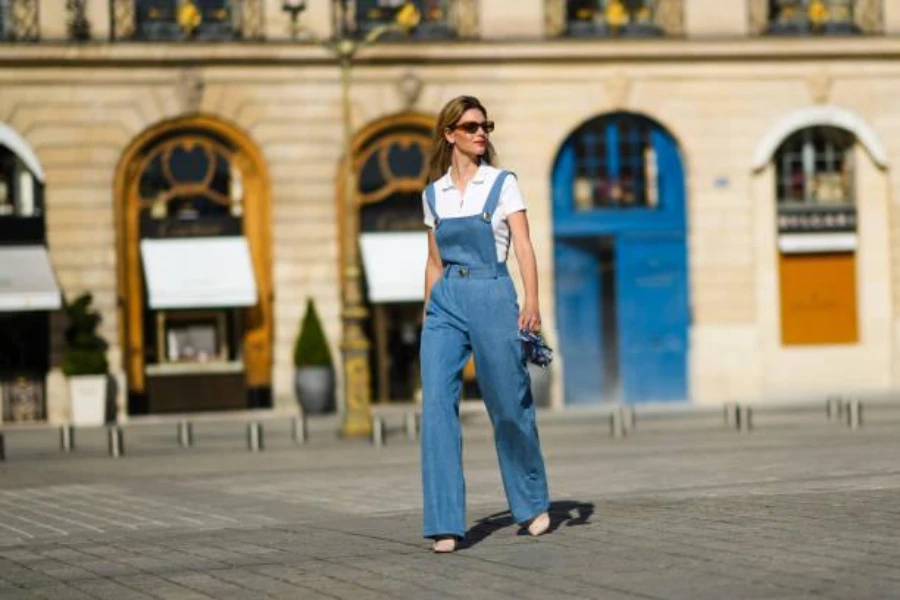 woman wearing denim overalls and a white tee