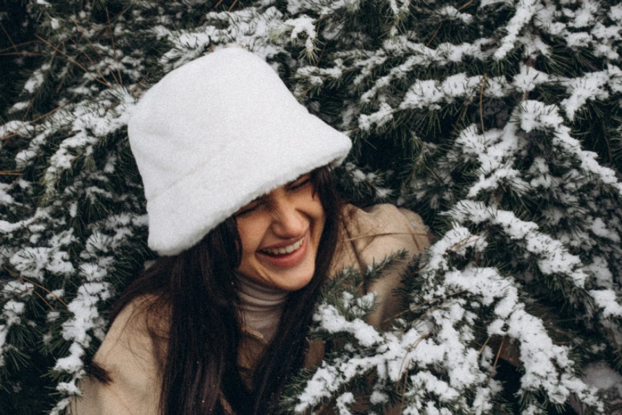 Woman wearing white fluffy bucket hat