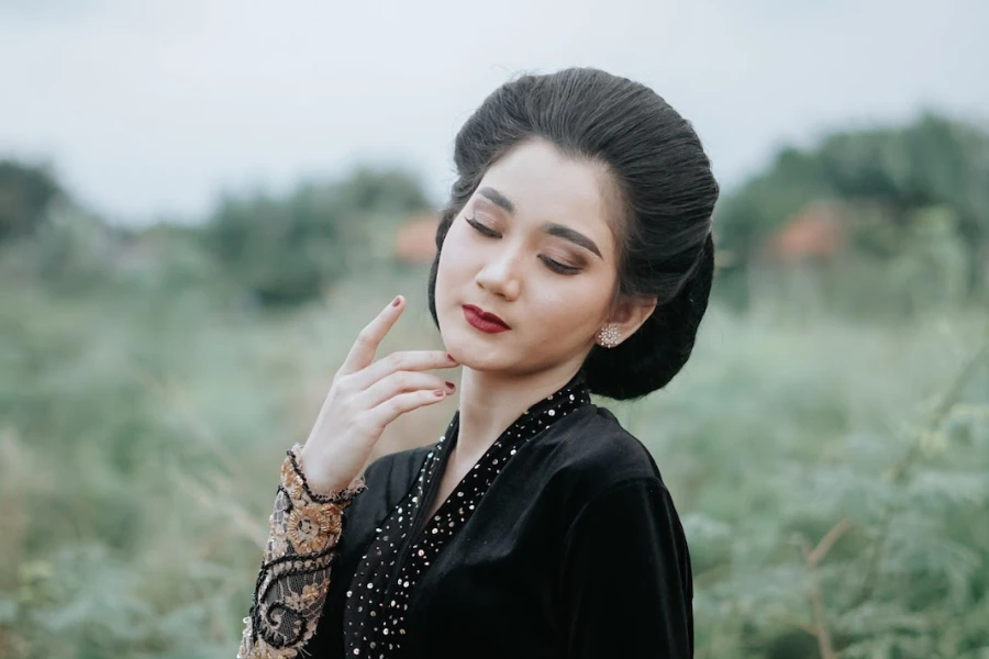 Woman with hair back, thick eyebrows, and red lips