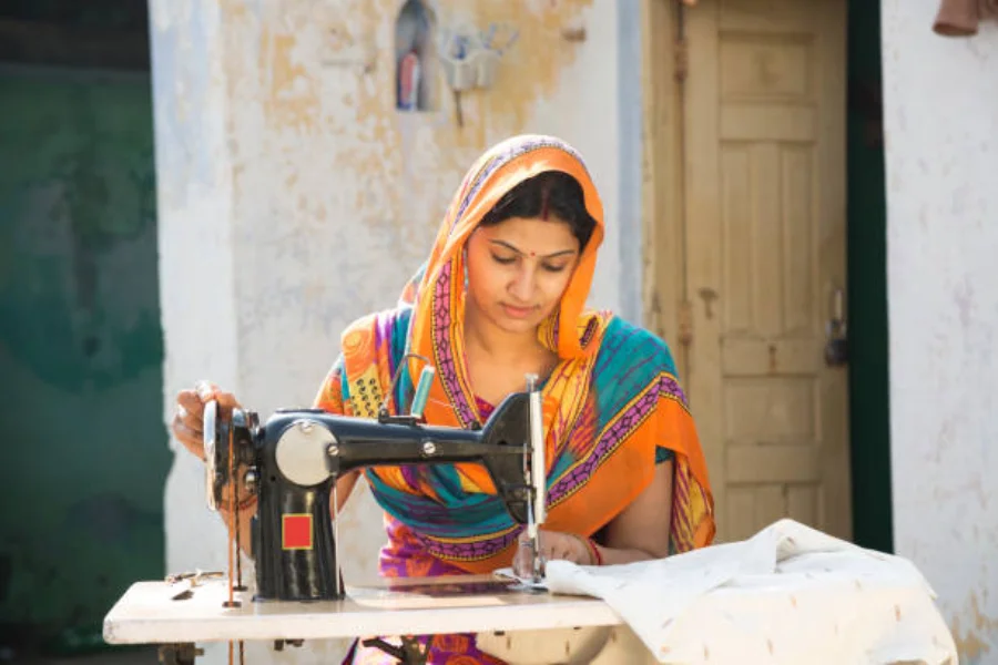 Woman working on a fabric using a domestic sewing machine