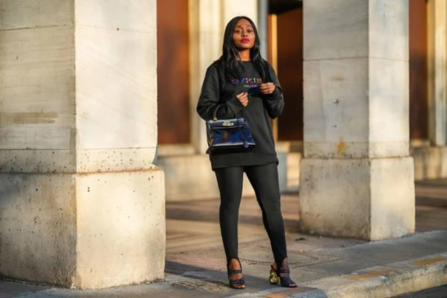 Young woman wearing black sweatshirt and leggings