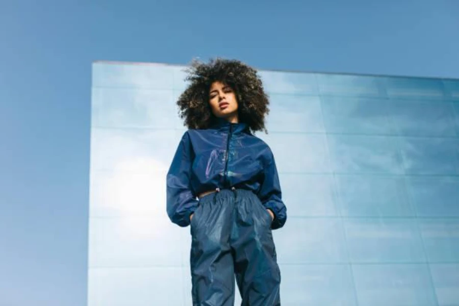 Young woman wearing matching blue tracksuit