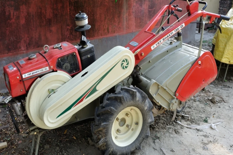 A stationary red power tiller