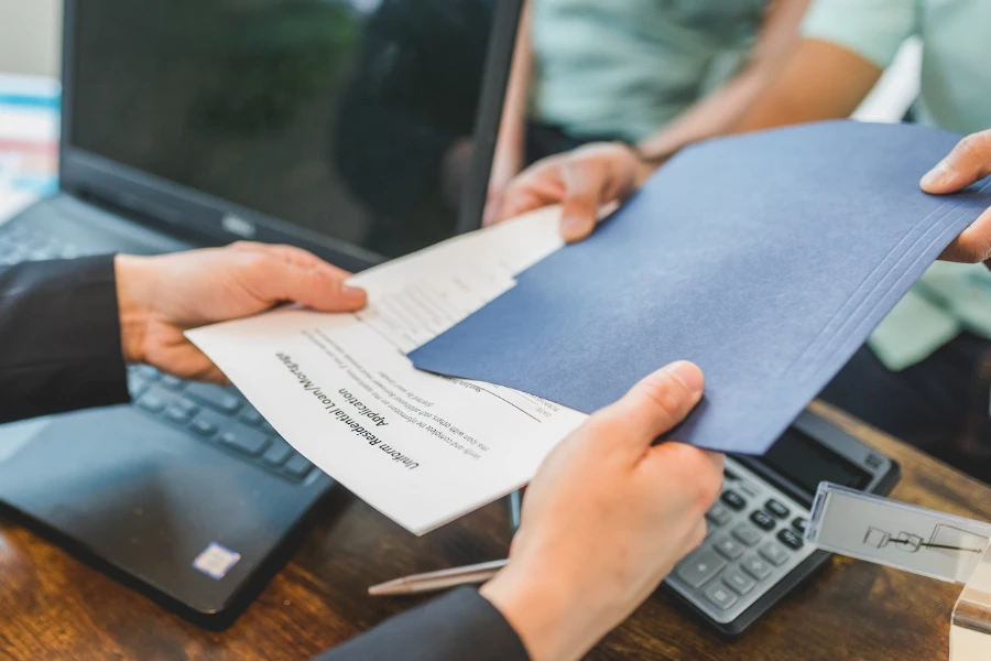 Agent giving a printed document to a buyer