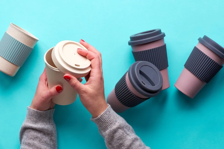Assorted bamboo reusable coffee or tea cups with silicone insulation