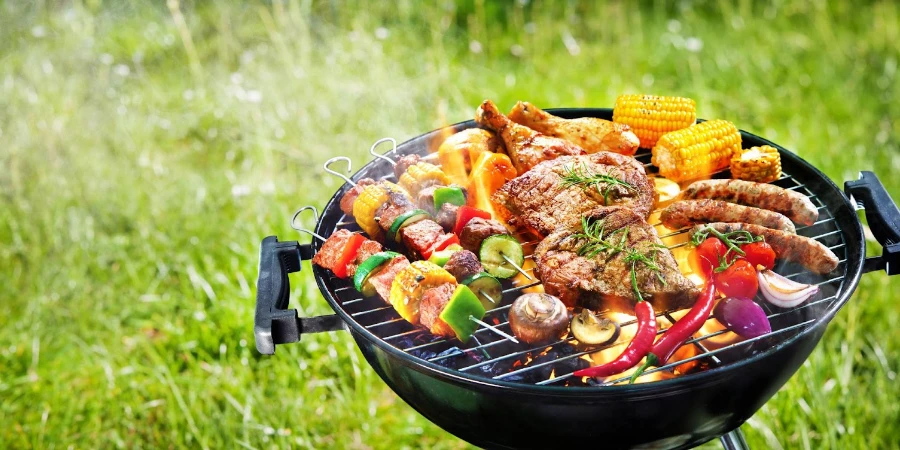 Assorted delicious grilled meat with vegetables on barbecue grill