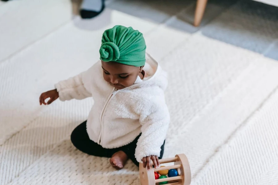 baby girl on turban playing