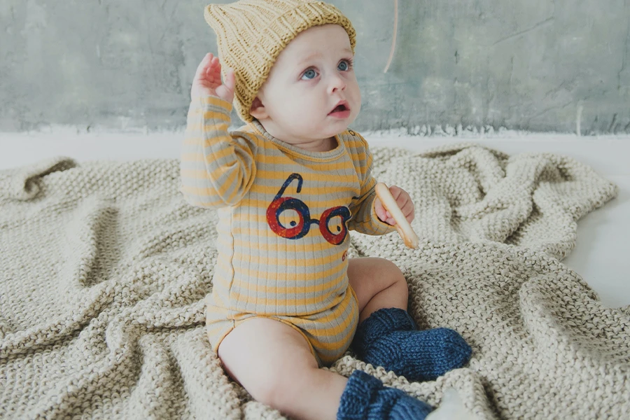 Baby wearing a three-piece hat and socks set