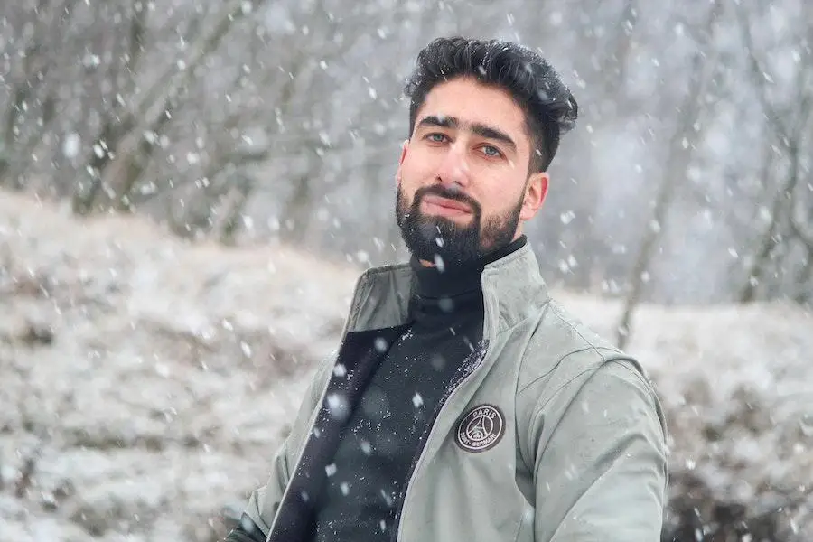 Bearded man rocking a winter jacket and black turtleneck