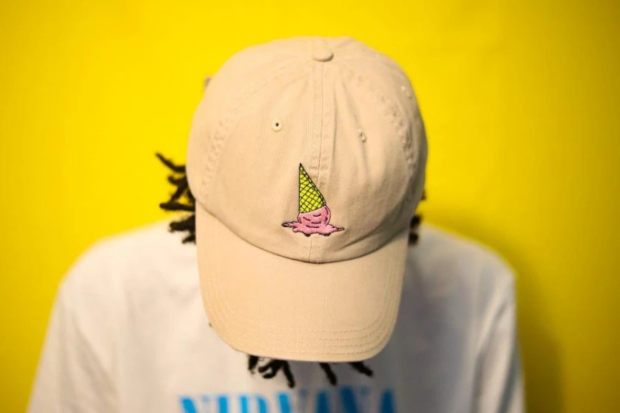 Beige baseball hat with melting ice cream cone logo