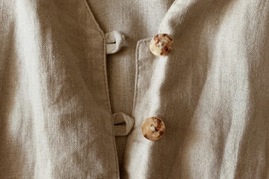 Beige linen shirt with irregular finish buttons