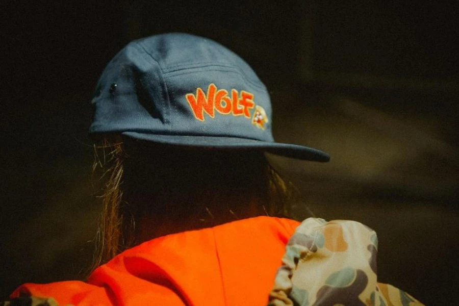 Blue unstructured cap with orange embroidered lettering