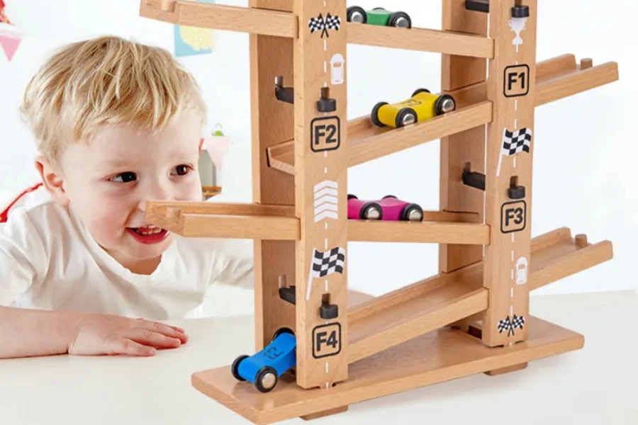 Boy playing with wooden race track on different tiers