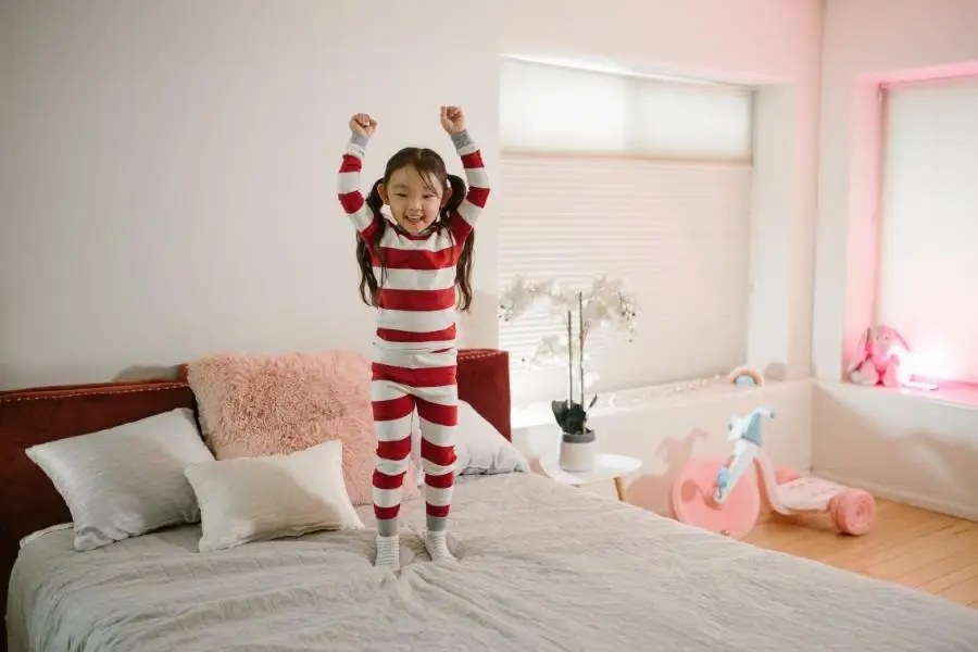 Child in matching striped two-piece pajamas