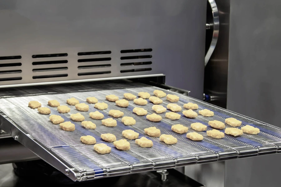 Close-up of chicken nuggets on a conveyor belt