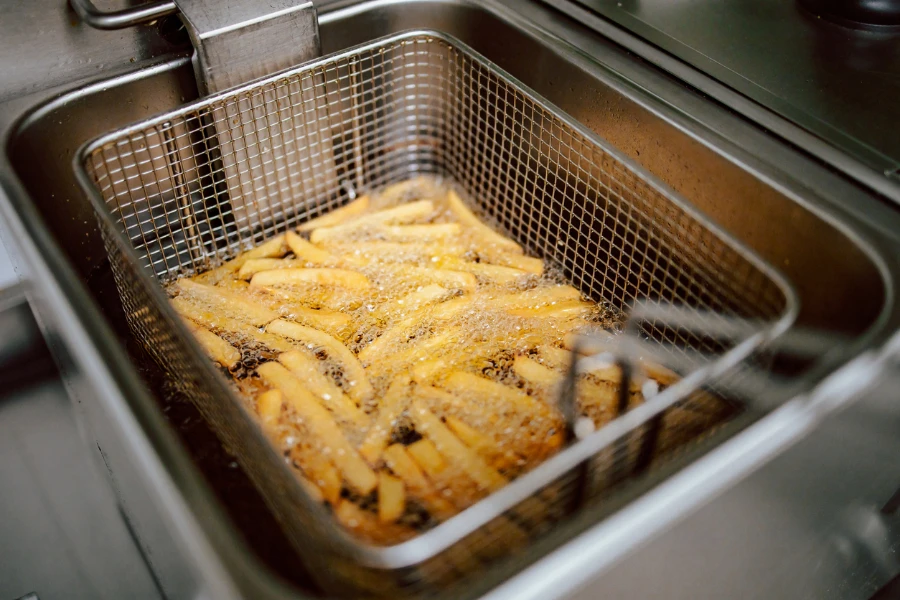 Close-up of fries in deep fryer