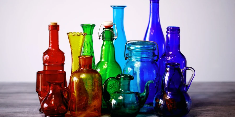 Collection of colored glass bottles, jars, and containers