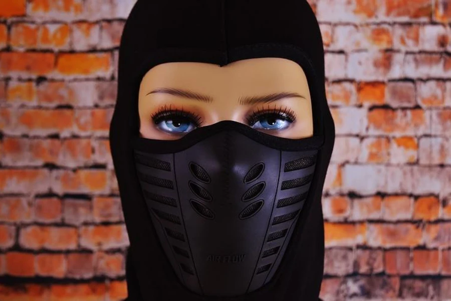 Doll in a black solid-front balaclava