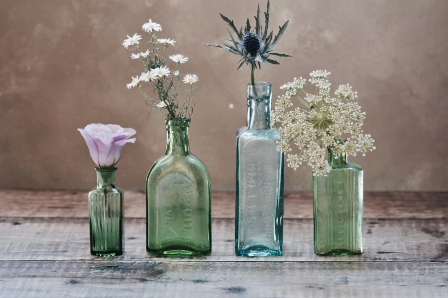 Four glass vases with flowers