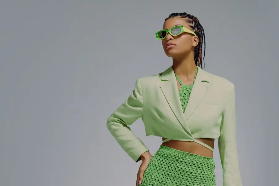 Lady posing in an outfit with multiple shades of green