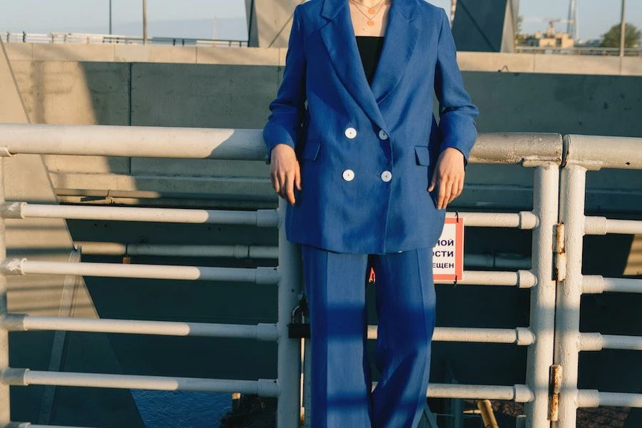 Lady resting on a fence in a blue adjustable blazer
