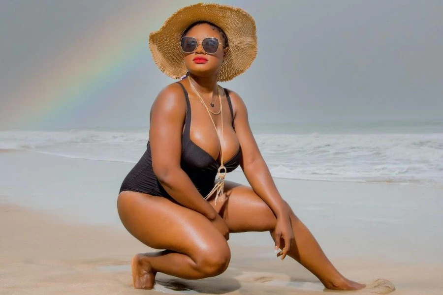 Lady rocking a black swimsuit and straw hat