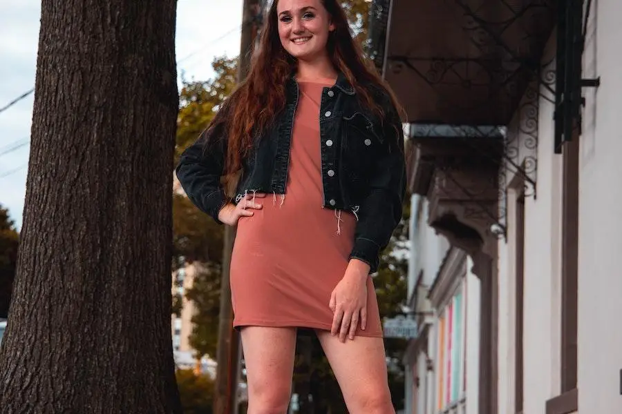 Lady rocking a jacket and pastel-colored mini dress