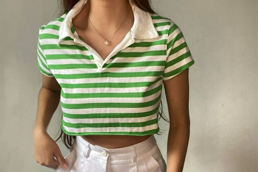 Lady wearing a green and white striped polo top