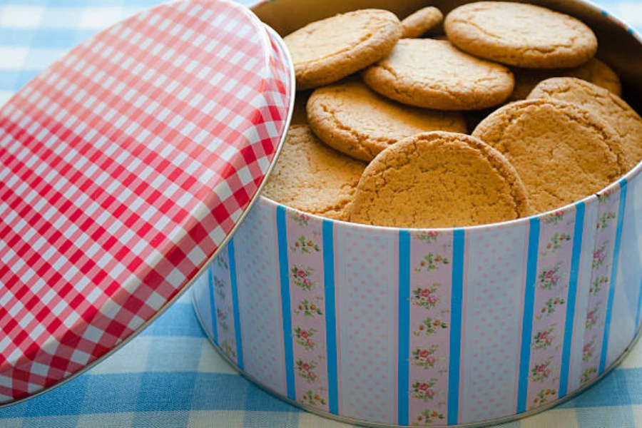 Large metal cookie tin with cookies inside of it