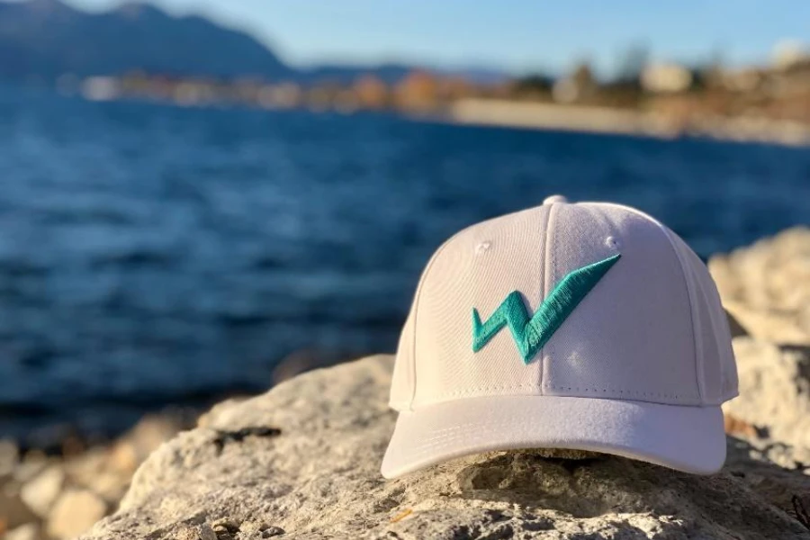 Light pink cap with teal 3D embroidered logo