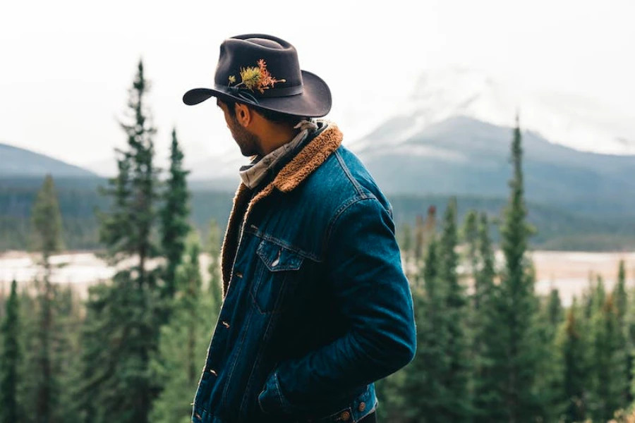 Man in the woods wearing a wide-brim cowboy hat