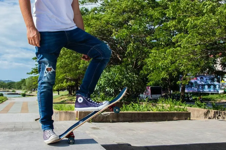 Man on a skateboard rocking ripped tapered jeans