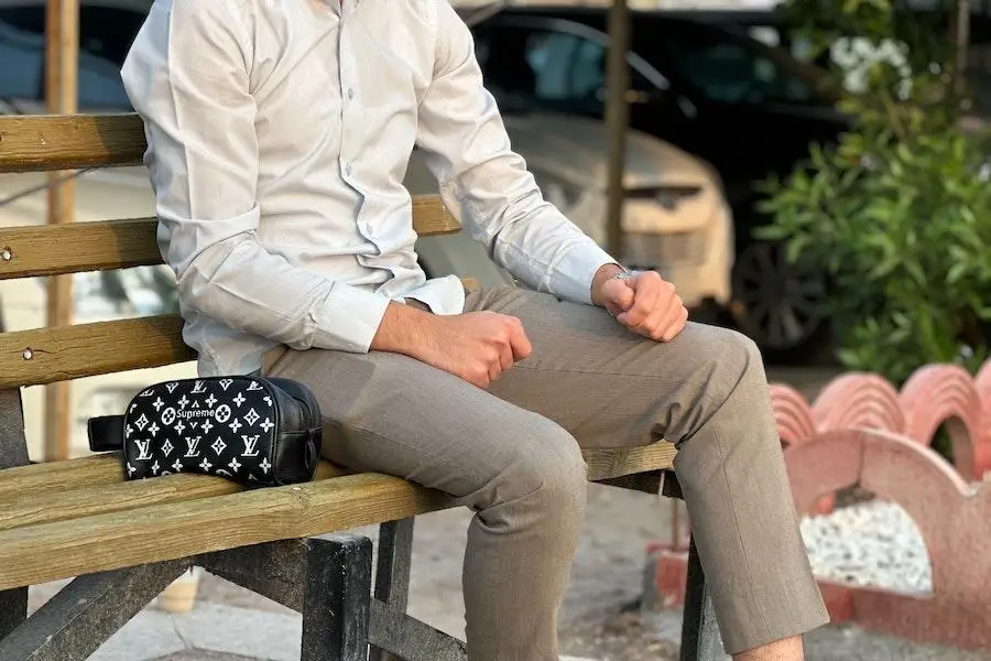 Man sitting on a bench in work attire