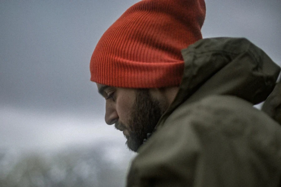 Man wearing an orange knit slouchy beanie hat