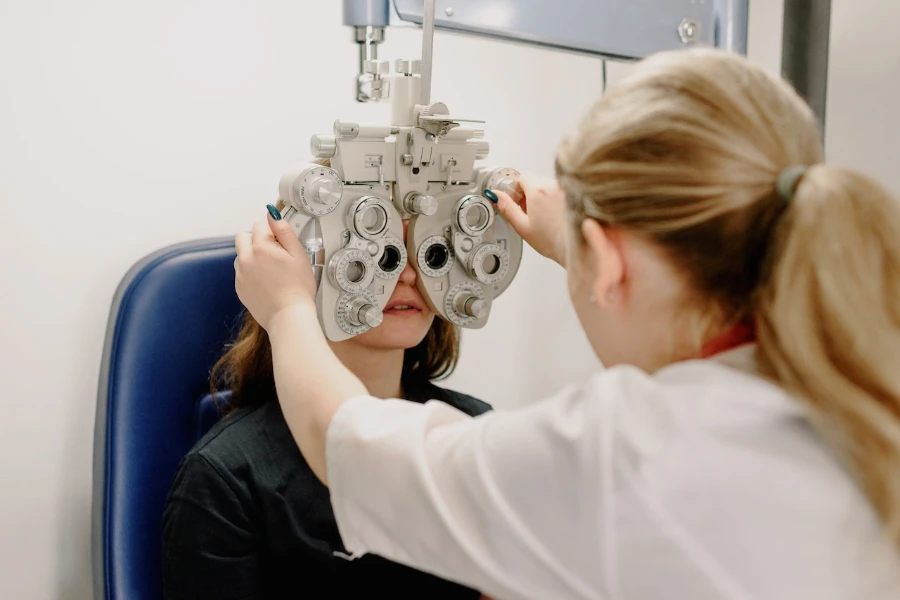Ophthalmologist checking vision of patient