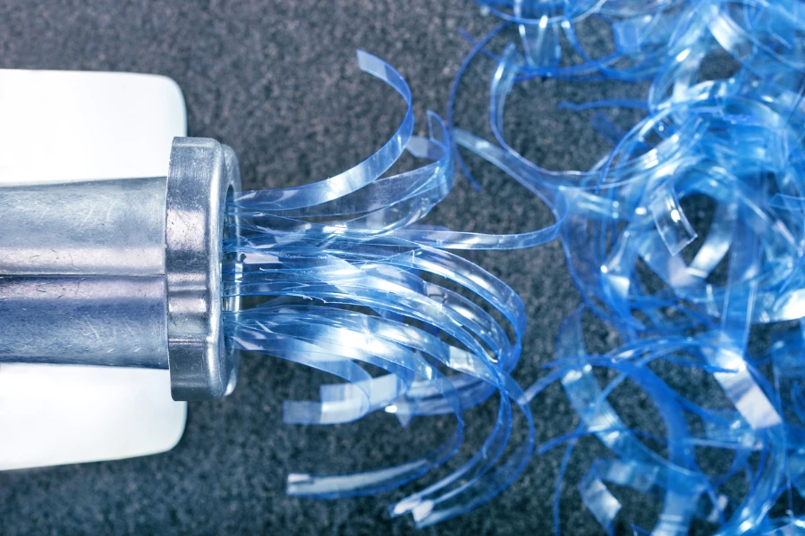 Plastic being cut in small pieces to be recycled