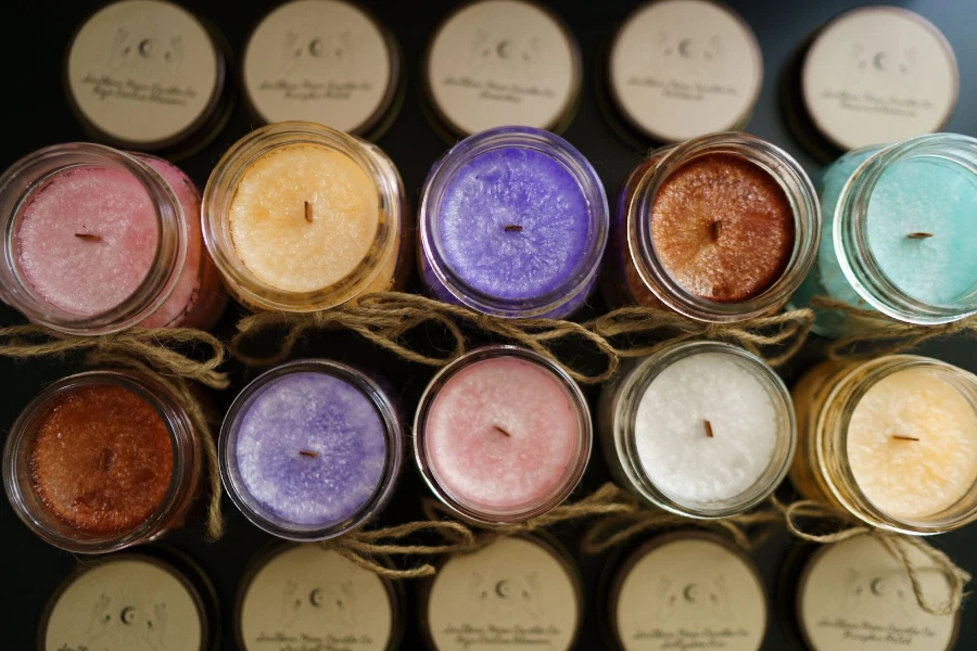 Rows of colored candles in glass jars