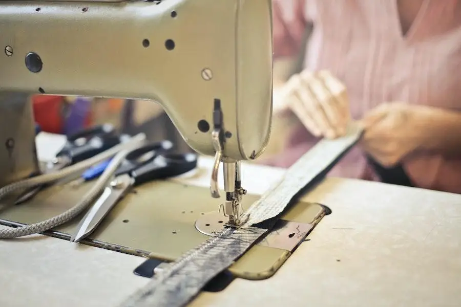 Seamstress stitching fabric using a sewing machine