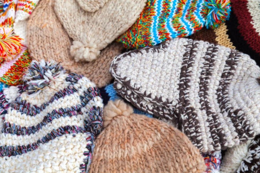 Selection of knitted multi-colored beanies in a pile