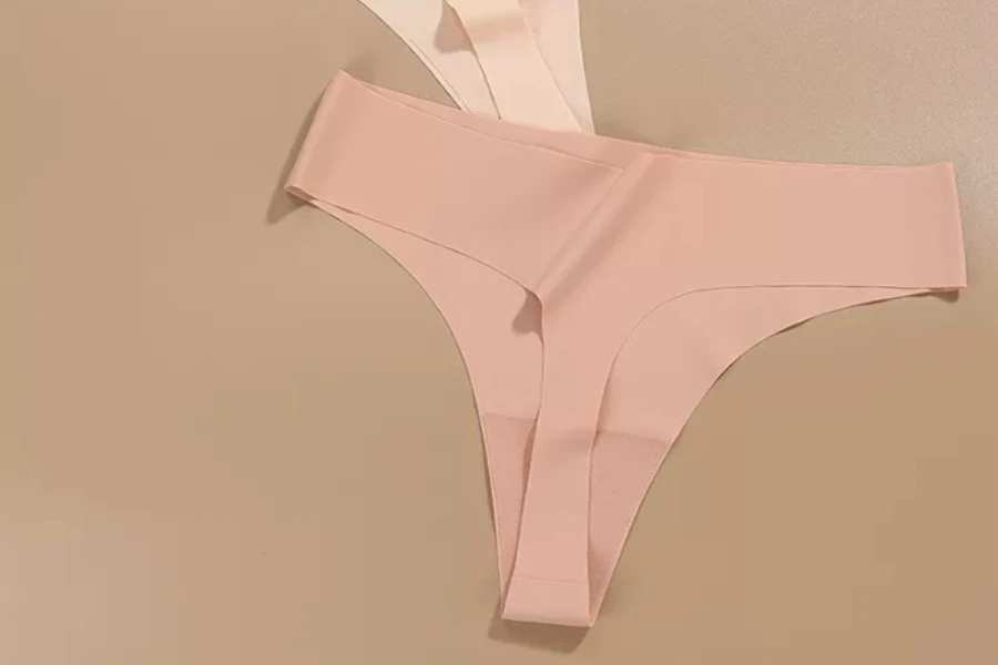 Slik seamless string panties on a brown background