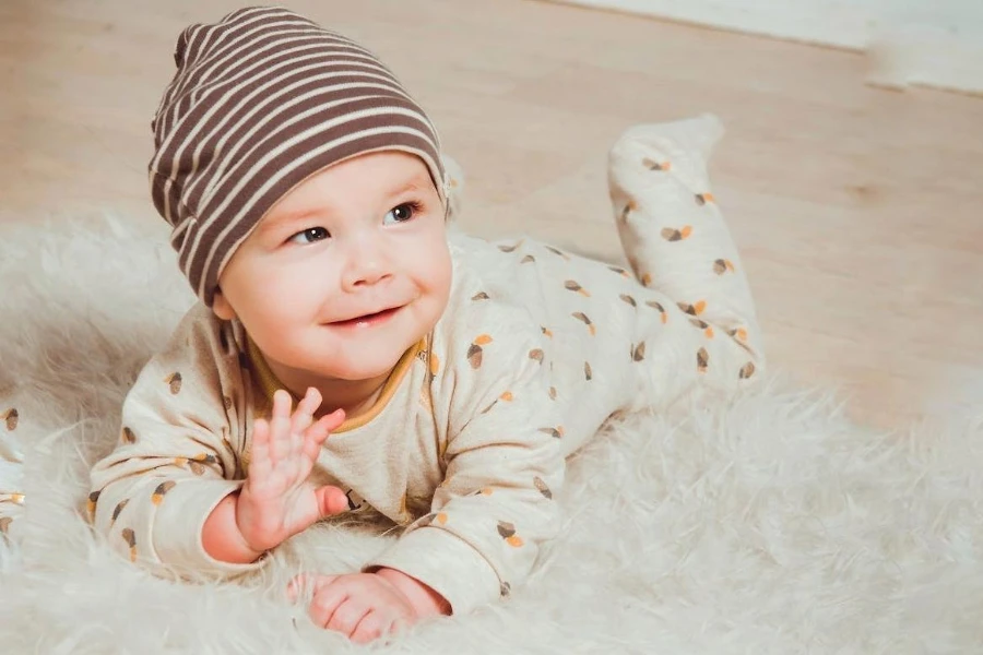 Smiling baby wearing patterned baby rompers