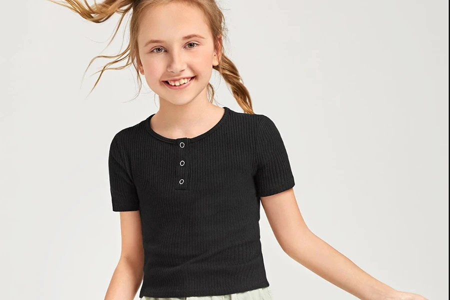 Smiling girl wearing a black half-button tee