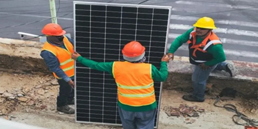 solar installers holding a solar panel