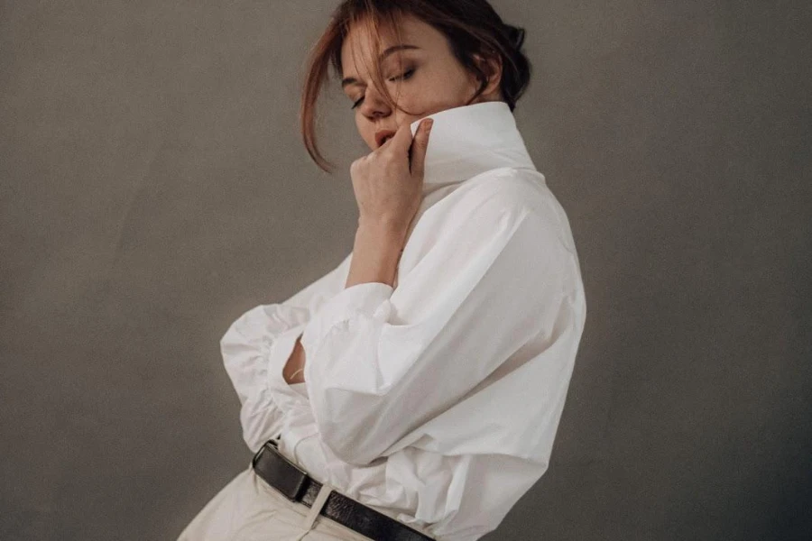 Stylish woman posing in a white classic shirt