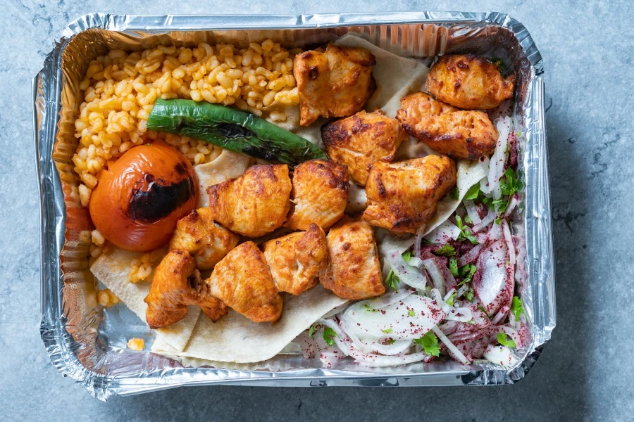 Take-away Turkish kebab in aluminum foil container