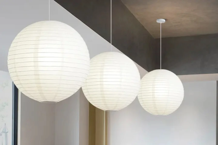 Three white round paper lanterns hanging from restaurant ceiling