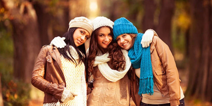 Three women wearing different colors of warm beanie hats
