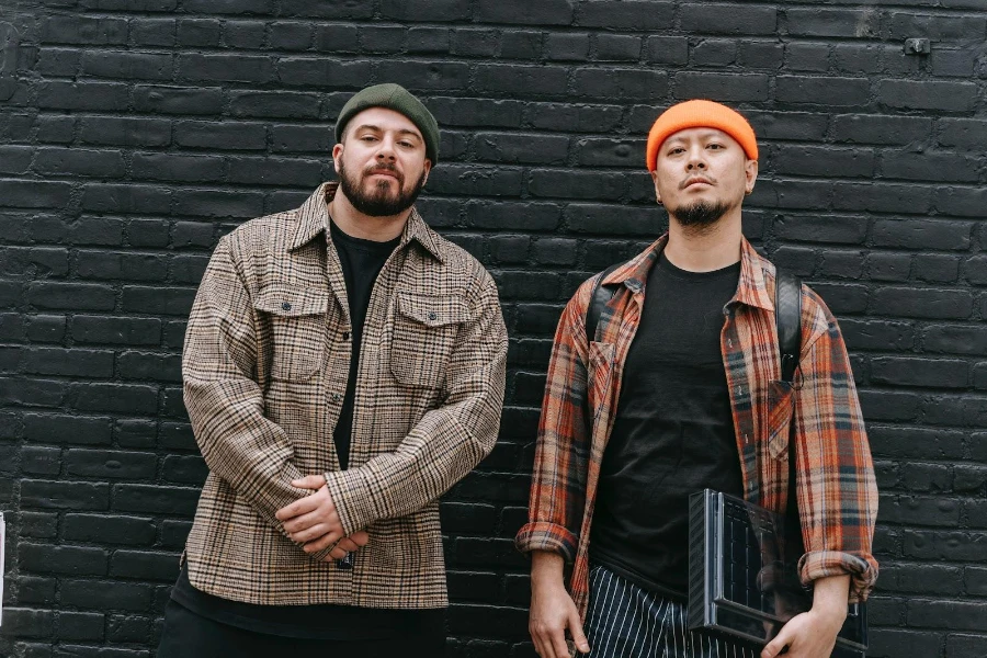 Two men wearing beanies and flannel shirts